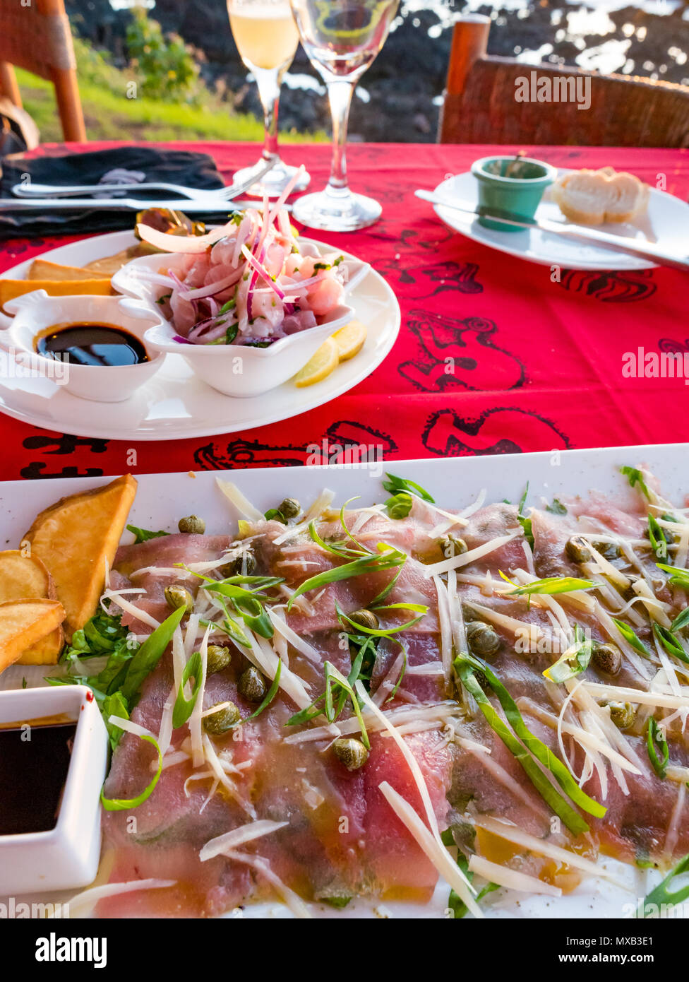 Starter of tuna fish carpaccio with capers, restaurant table,Tataku Vave restaurant, Hanga Roa, Easter Island, Rapa Nui, Chile Stock Photo