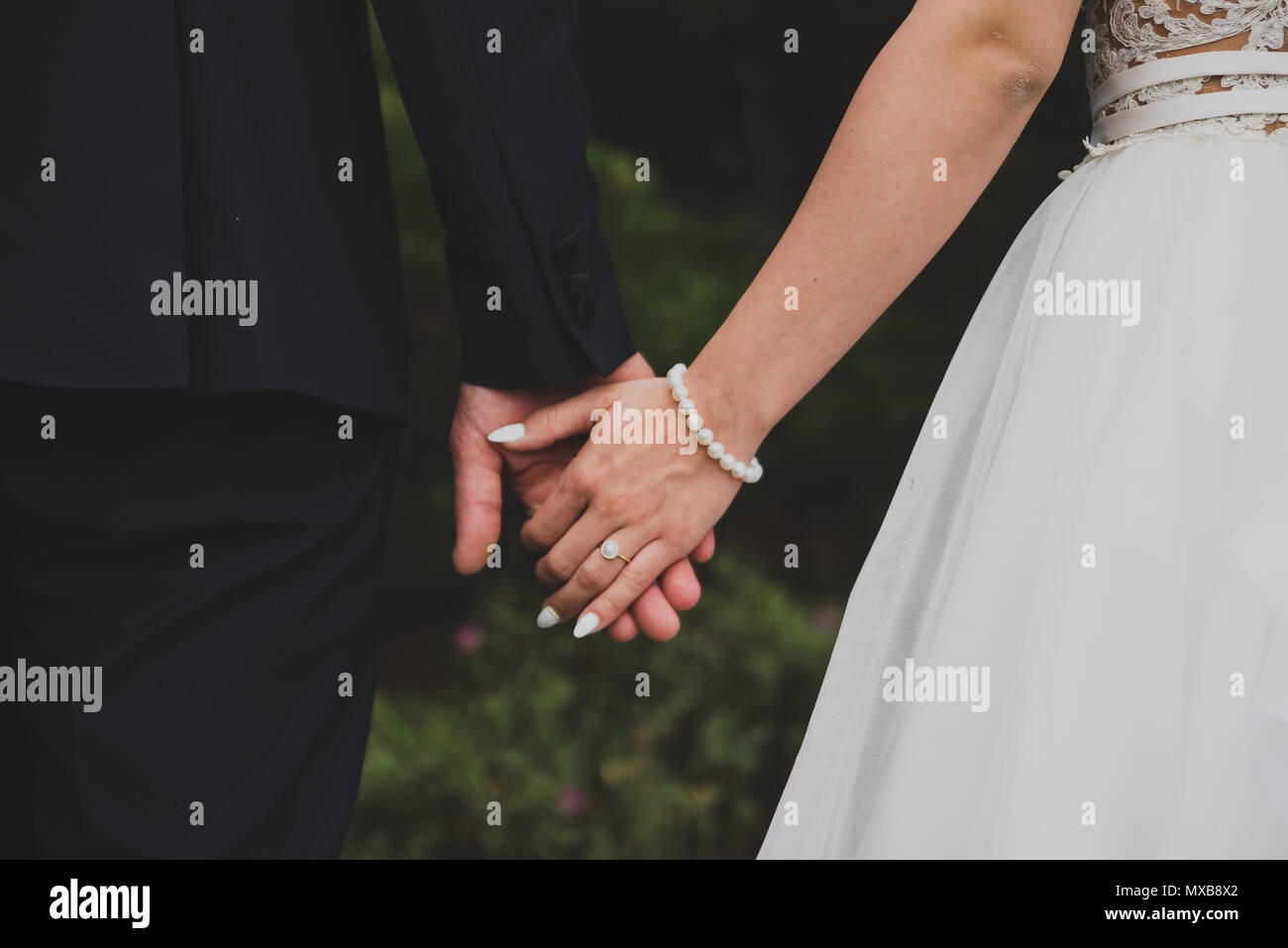 Couple holding hands in nature hi-res stock photography and images - Alamy