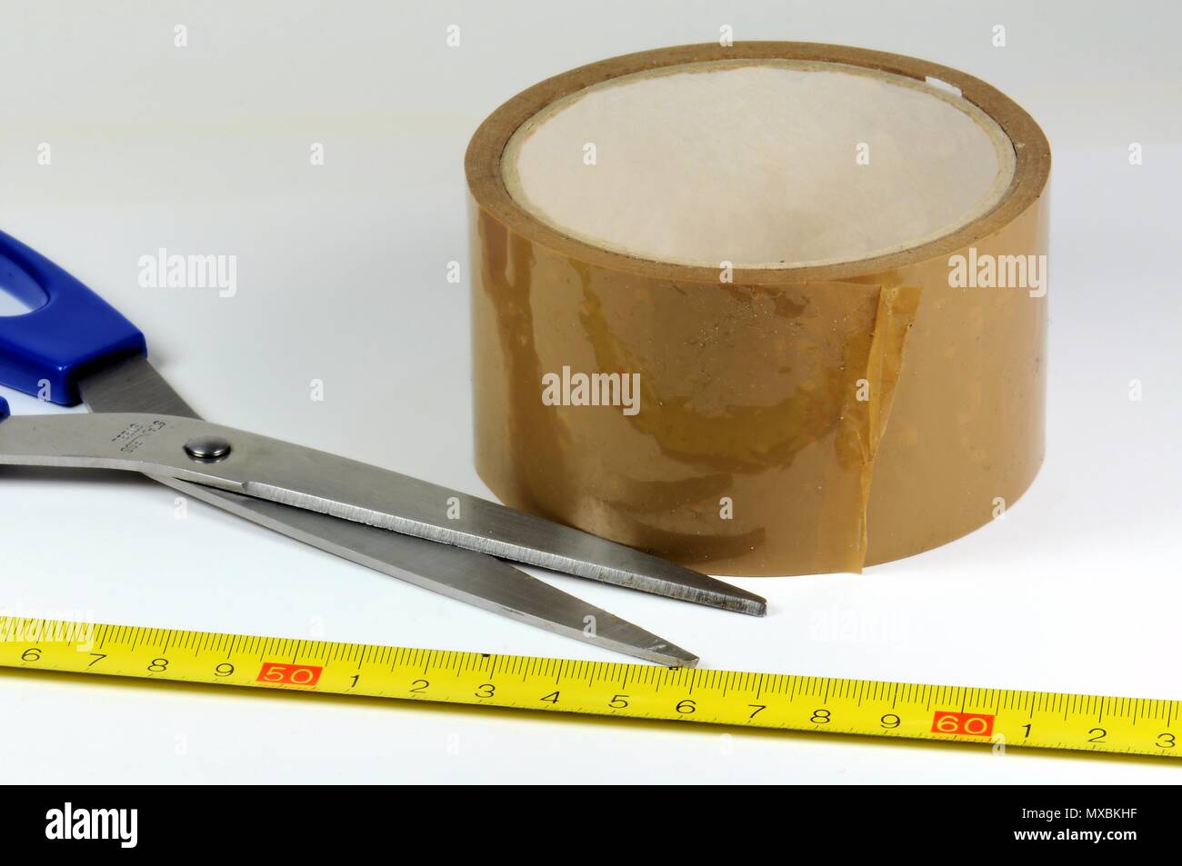 Group of tools. Tape measure in decimal system, scissors and adhesive