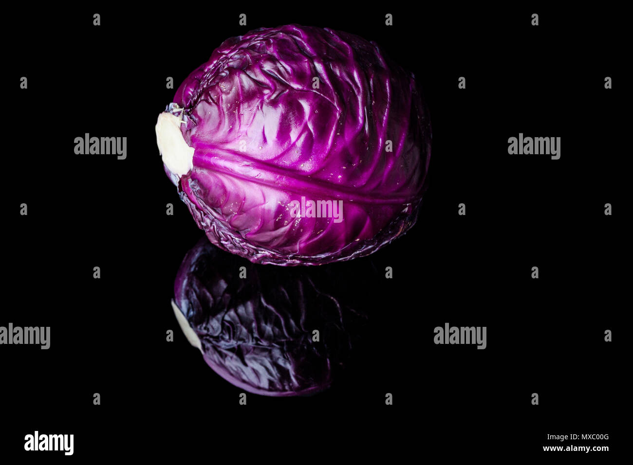 Purple cabbage head on black background with reflection Stock Photo Alamy