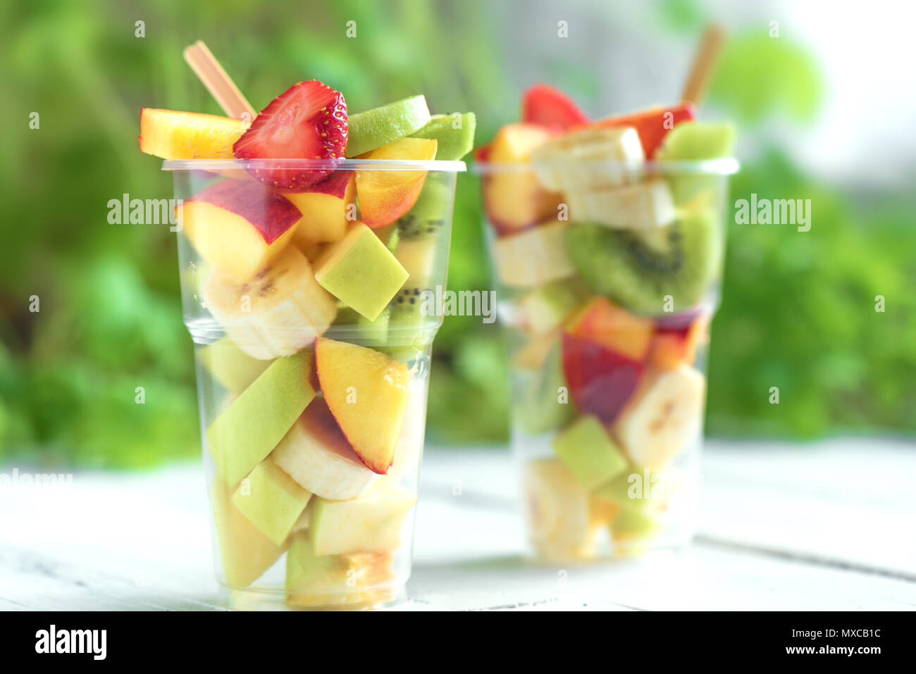 https://c8.alamy.com/comp/MXCB1C/fruit-salad-in-plastic-cups-takeaway-sliced-organic-fruits-and-berries-healthy-snack-to-go-copy-space-MXCB1C.jpg
