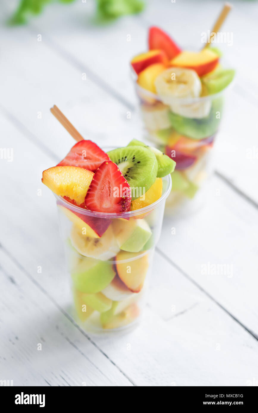 https://c8.alamy.com/comp/MXCB1G/fruit-salad-in-plastic-cups-takeaway-sliced-organic-fruits-and-berries-healthy-snack-to-go-copy-space-MXCB1G.jpg