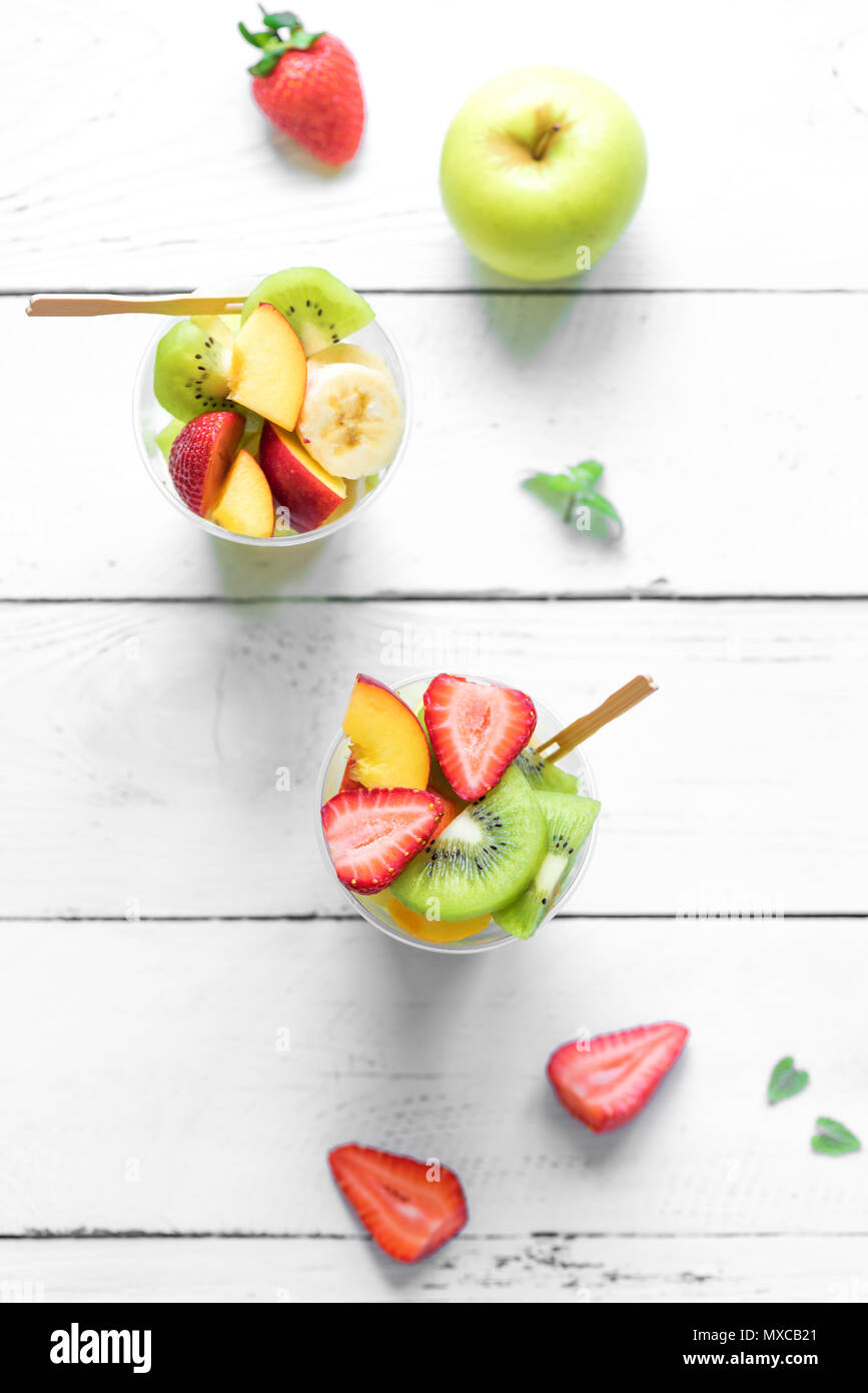 Fruit salad in plastic cups takeaway. Sliced organic fruits and berries