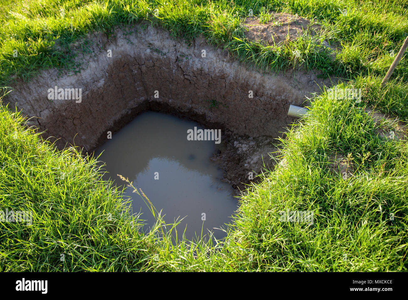 big hole in the ground, collector close up Stock Photo Alamy