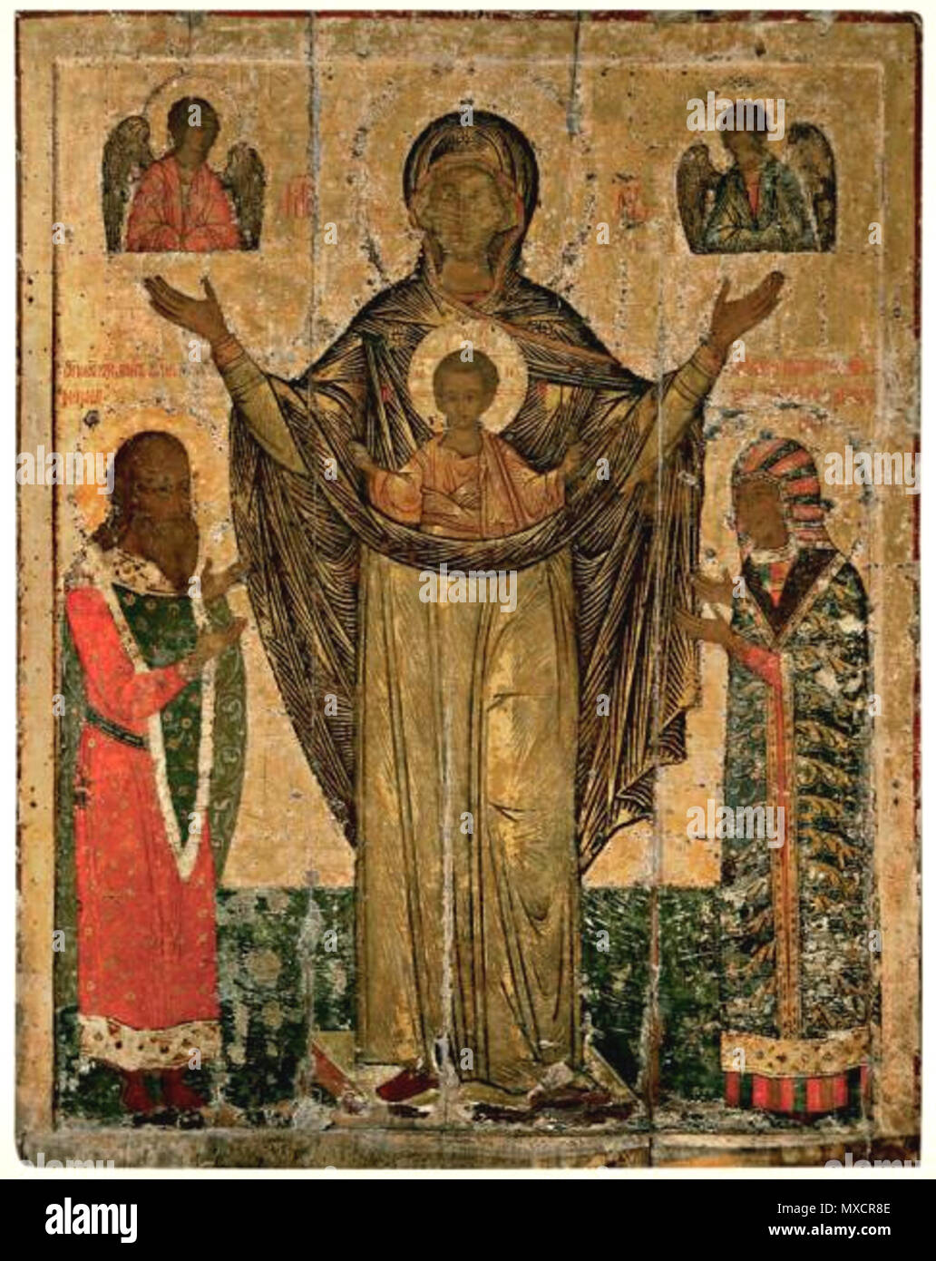 . Our lady of Mirozh with pskov prince S. Dovmont and his wife S.Maria. Pskov museum. Список с чудотворной иконы Мирожской божьей матери, хранящейся в Мирожском монастыре. Псковский музей. Богоматерь на этой святой иконе изображена во весь рост стоящею с воздетыми руками и с предстоящими Ей святыми князьями Довмонтом Псковским и его супругой Марией Дмитриевной, начертанными на иконе уже после ее явления; празднование в честь ее совершается 24 сентября. БОГОМАТЕРЬ ВЕЛИКАЯ ПАНАГИЯ (МИРОЖСКАЯ ОРАНТА). 1583 (?) год. Псков. Дерево; темпера. 144 x 112 x 3. Поступила в 1926 (?) году из церкви св. Сте Stock Photo