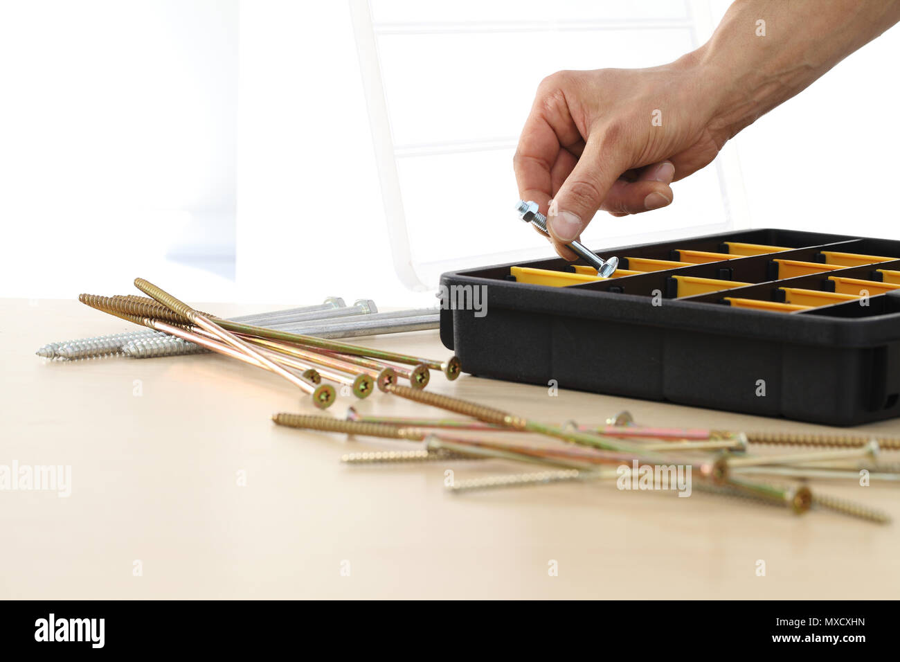 hand worker choose a nut bolts from the box, close up Stock Photo Alamy