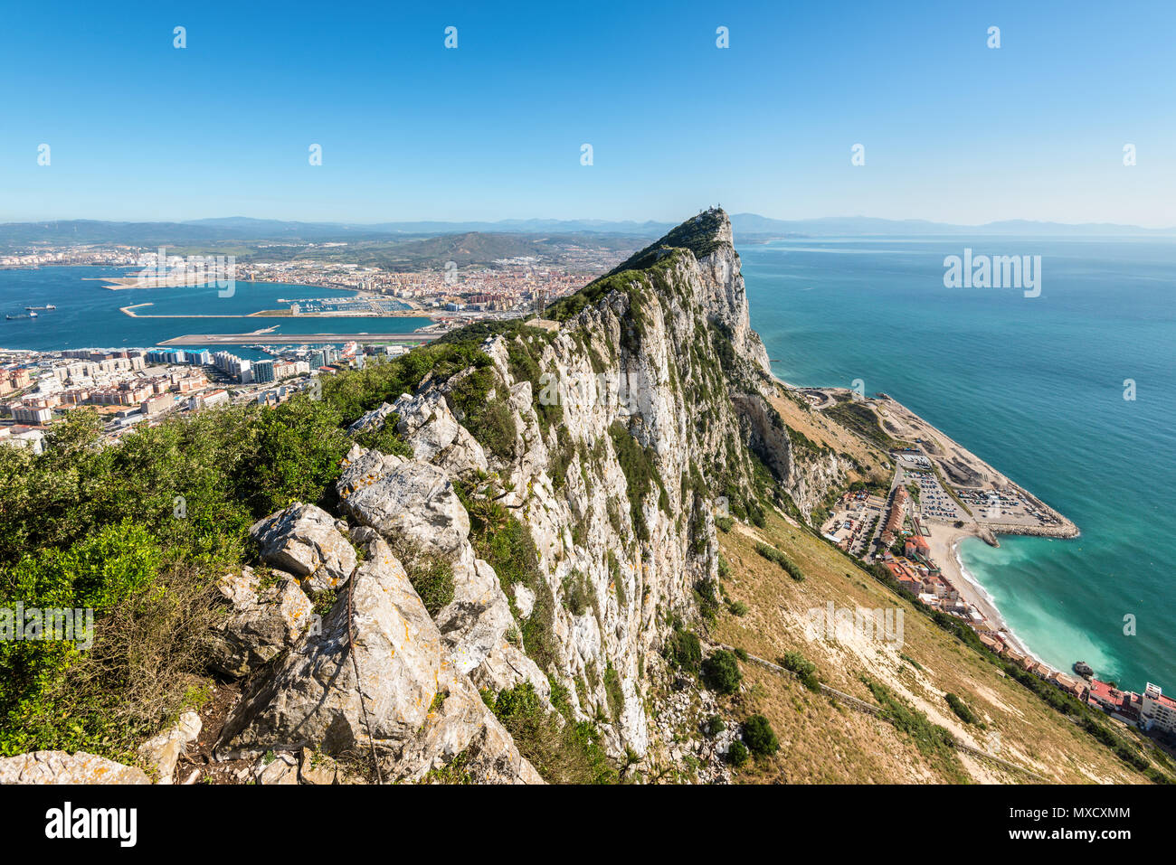 Aerial view of top of Gibraltar Rock, in Upper Rock Natural Reserve: on the left Gibraltar town and bay, Mediterranean Sea on the right, United Kingdo Stock Photo