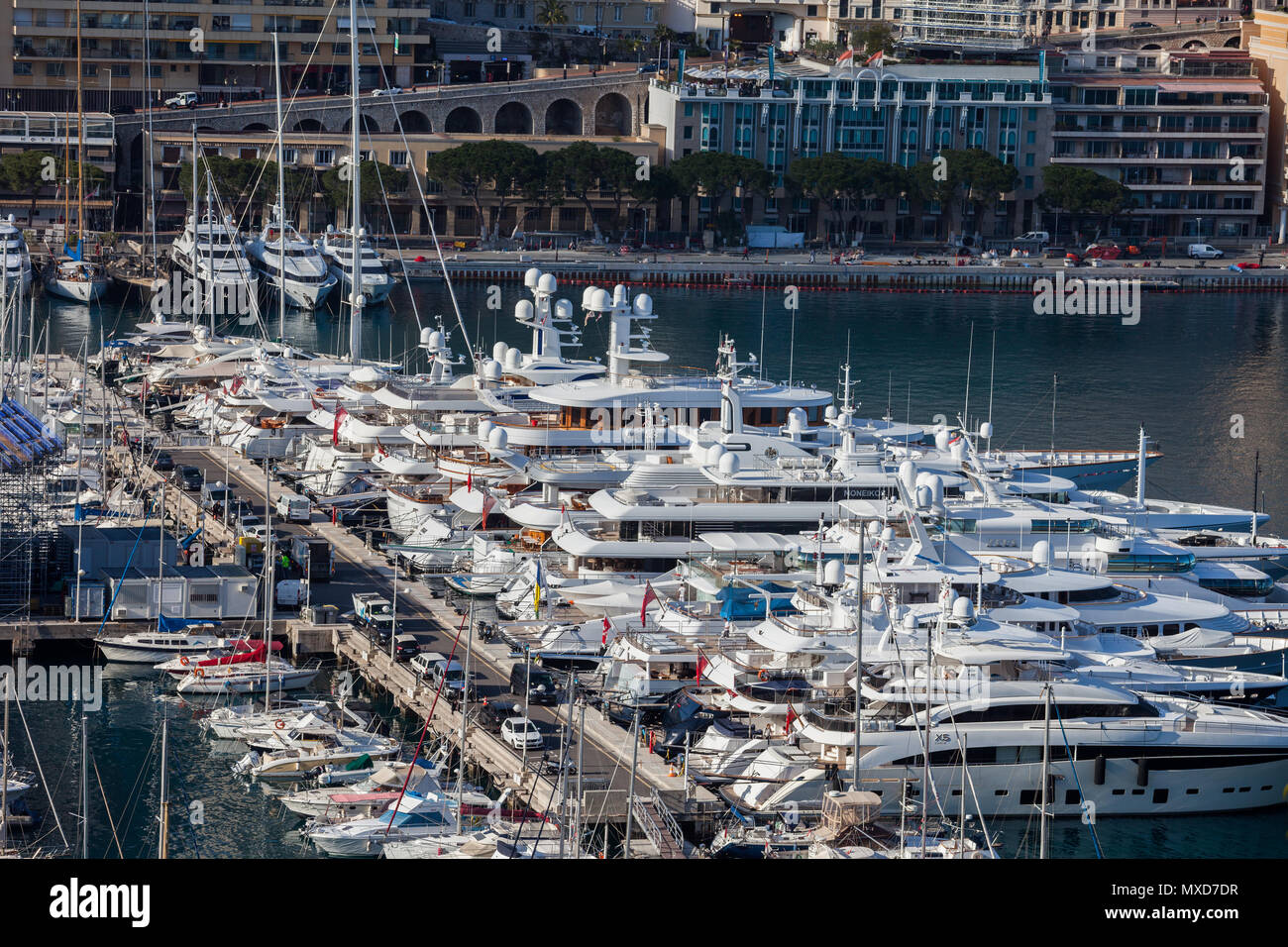 Monaco principality, luxury yachts and boats in Port Hercule on Mediterranean Sea, Monte Carlo in the background Stock Photo