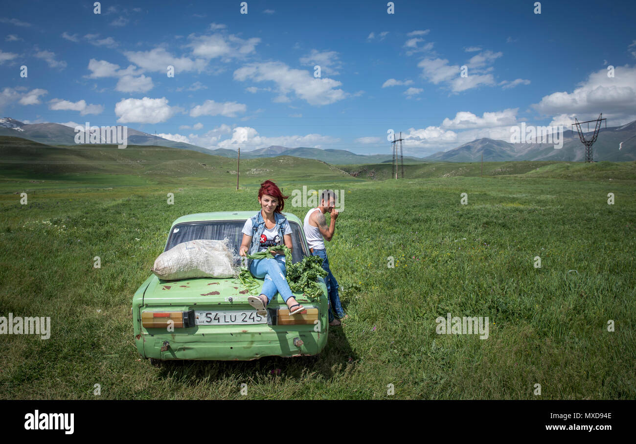 Areni, Armenia, 1st June, 2018: family with their car on the raodside, selling mushrooms and other herbs to passbyers Stock Photo