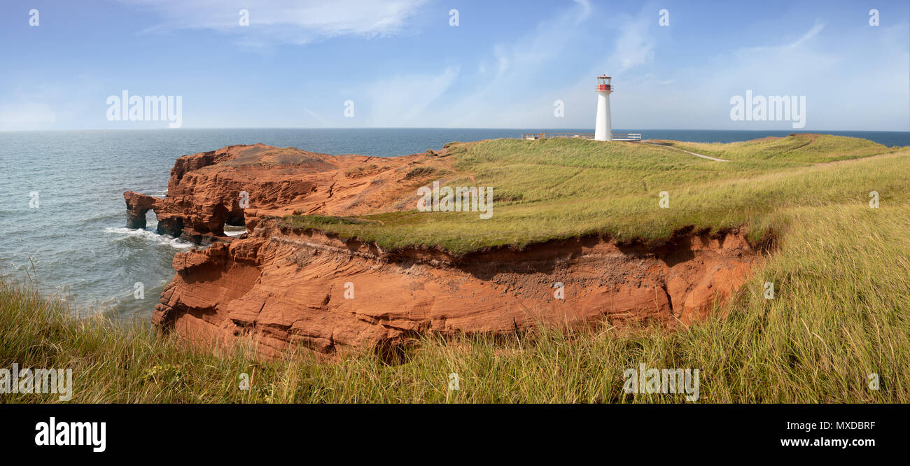 Panarama of the Borgot, or Cape Herisse lighthouse of Cap aux Meules, Magdalen Islands, Canada. The lighthouse stands on the rugged red cliffs of the  Stock Photo