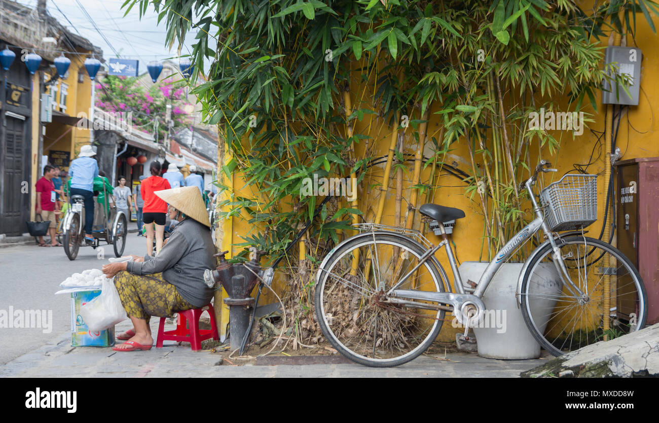 vietnam woman vendor selling traditional sweets on street corner Stock Photo