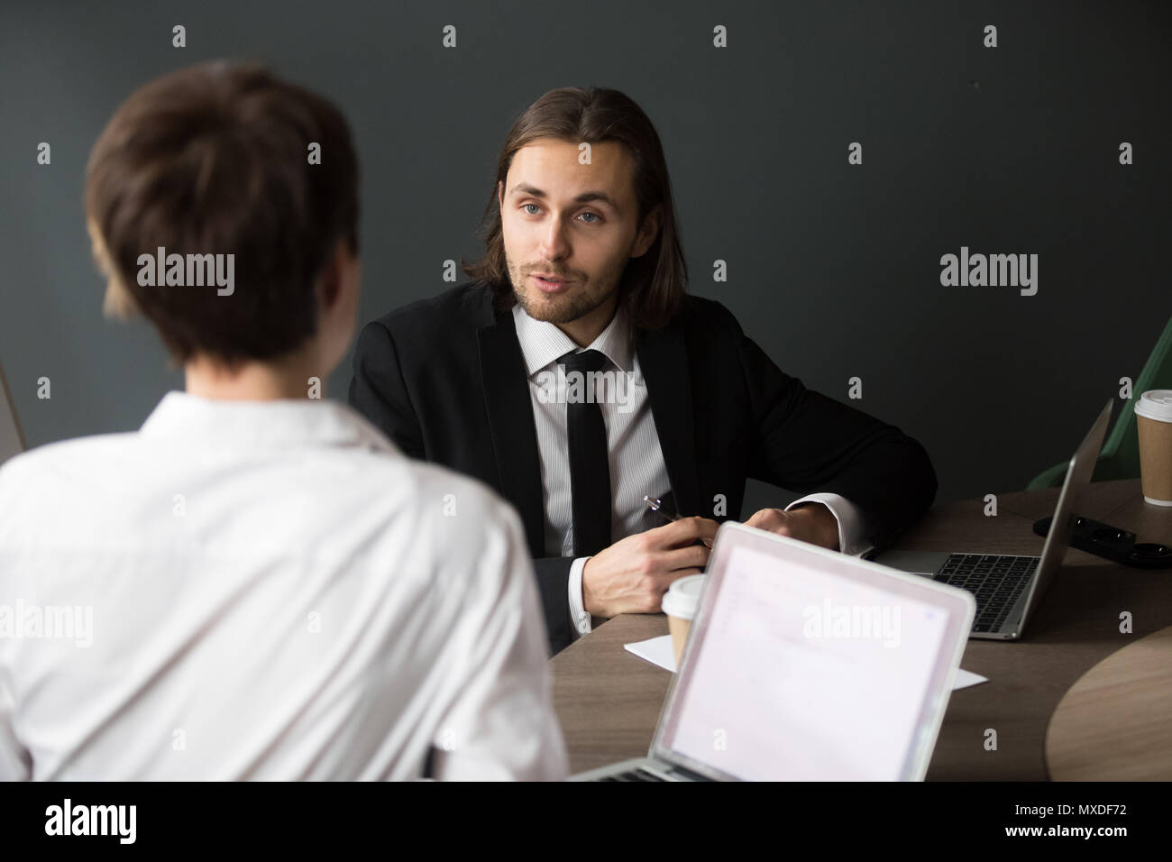 Businessman sharing business ideas with female partner during bo Stock Photo