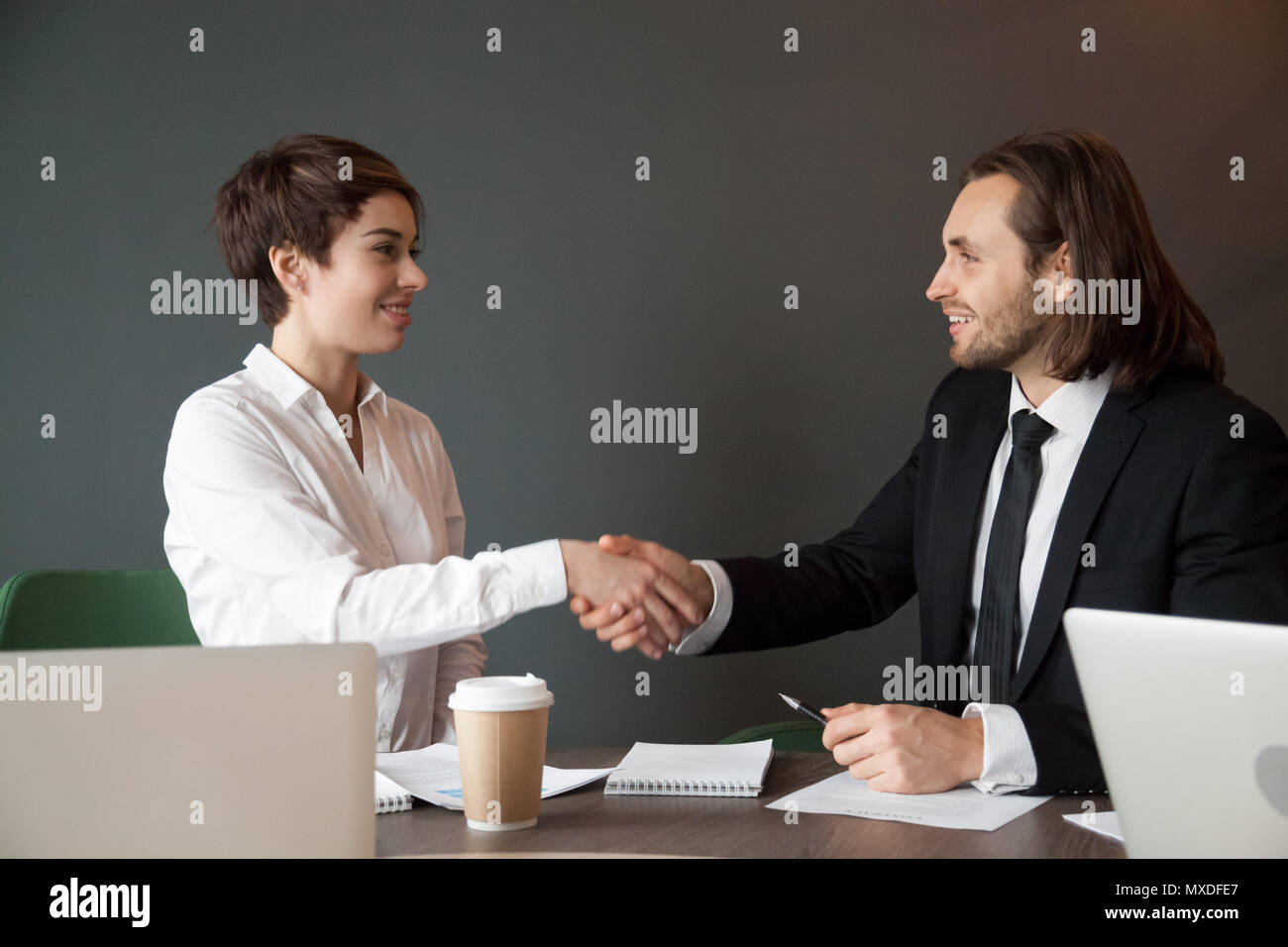 Business partners greeting with handshake during office meeting Stock Photo