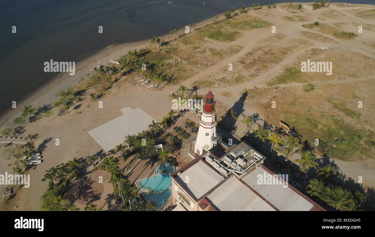 Coastline with beach and lighthouse. Aerial view: Coast sea with hotels, resorts, Subic Bay, Philippines, Luzon Stock Photo