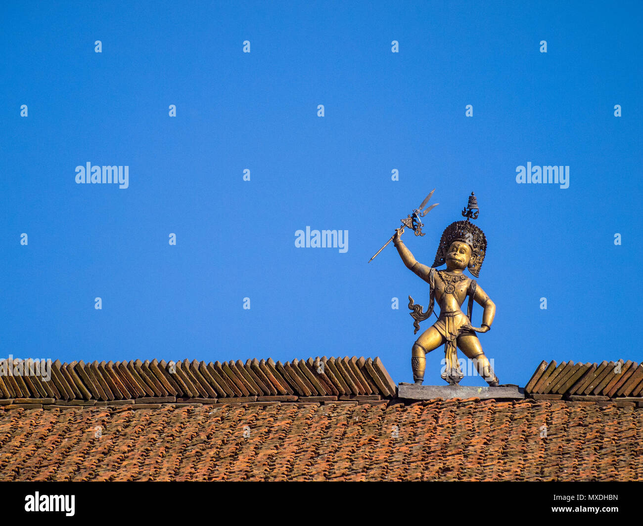 A statue of the Hindu deity Hanuman atop the Hanuman Dhoka, an old royal palace in Durbar Square, Patan, near Kathmandu, Nepal Stock Photo
