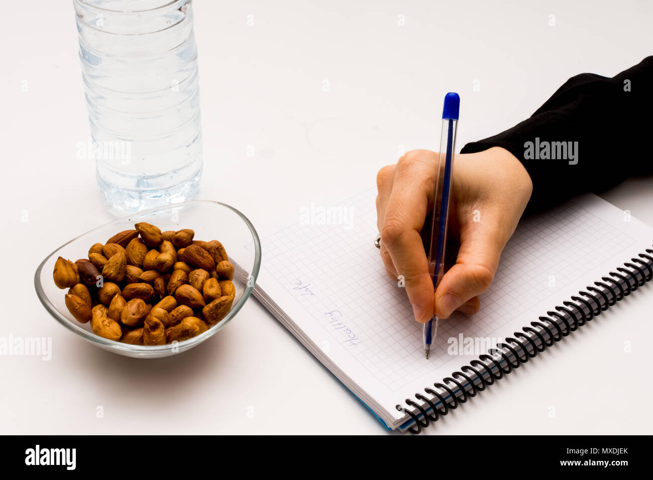 person on the job with hazelnuts and water to refresh it Stock Photo