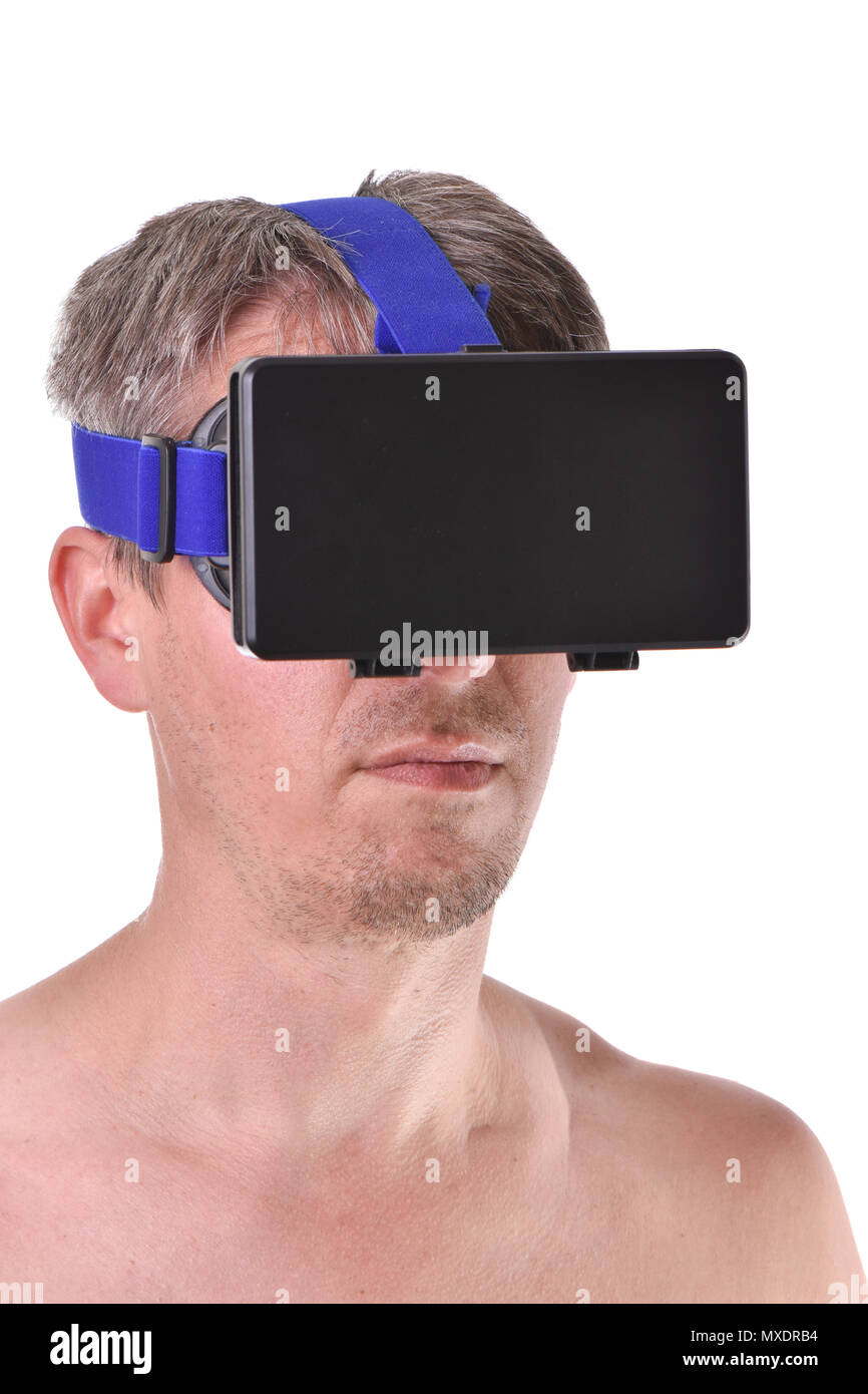 Young bearded topless man playing with visual reality glasses on white background. Stock Photo