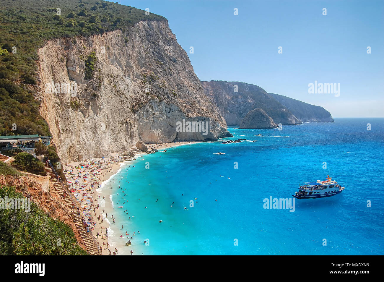 Porto Katsiki Beach, the most beautiful and famous in Lefkada; a small cruise ship stopped for a while in its way to Ithaca, the island of Odysseus Stock Photo