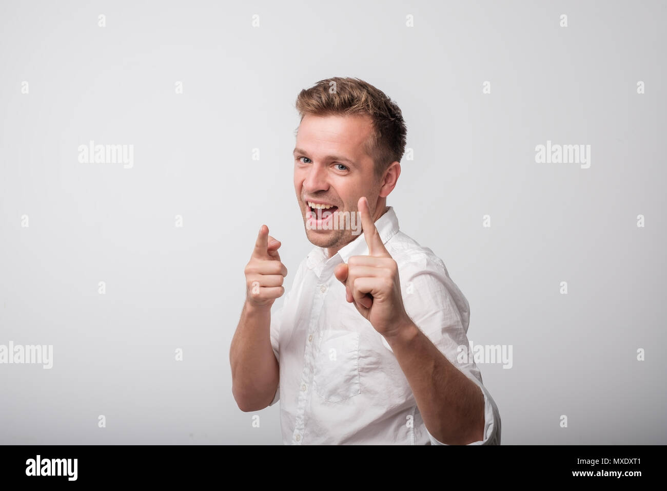 Happy caucasian man standing and smiling. Beautiful male half-length portrait. Stock Photo