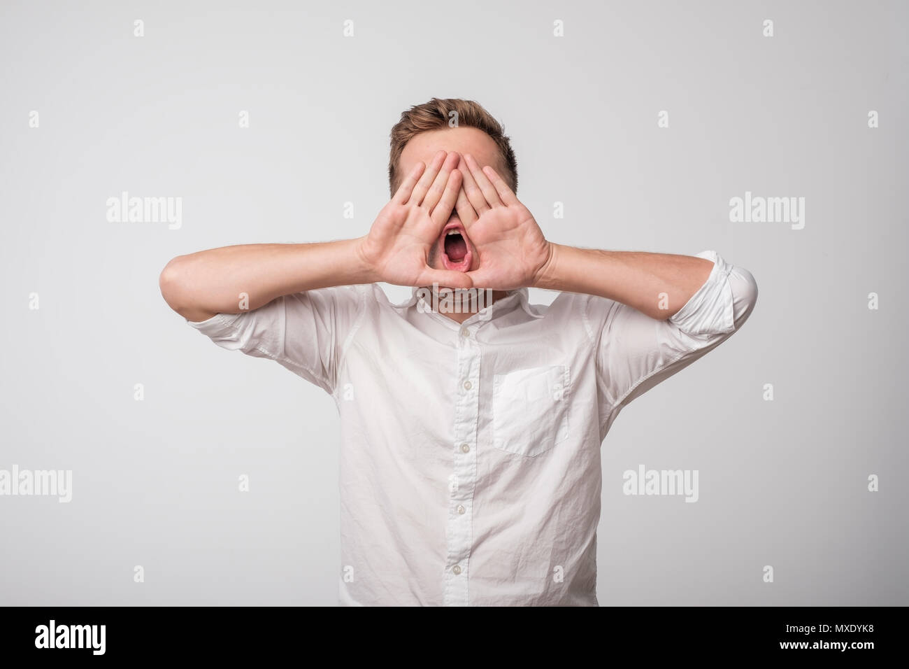 Attractive young caucasian man shouting. Stock Photo