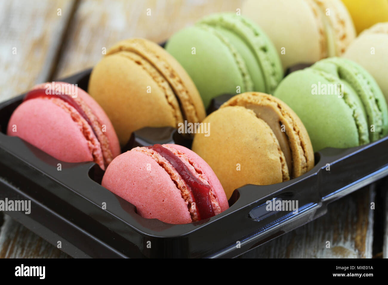 Selection of colorful delicious macaroons in box, closeup Stock Photo