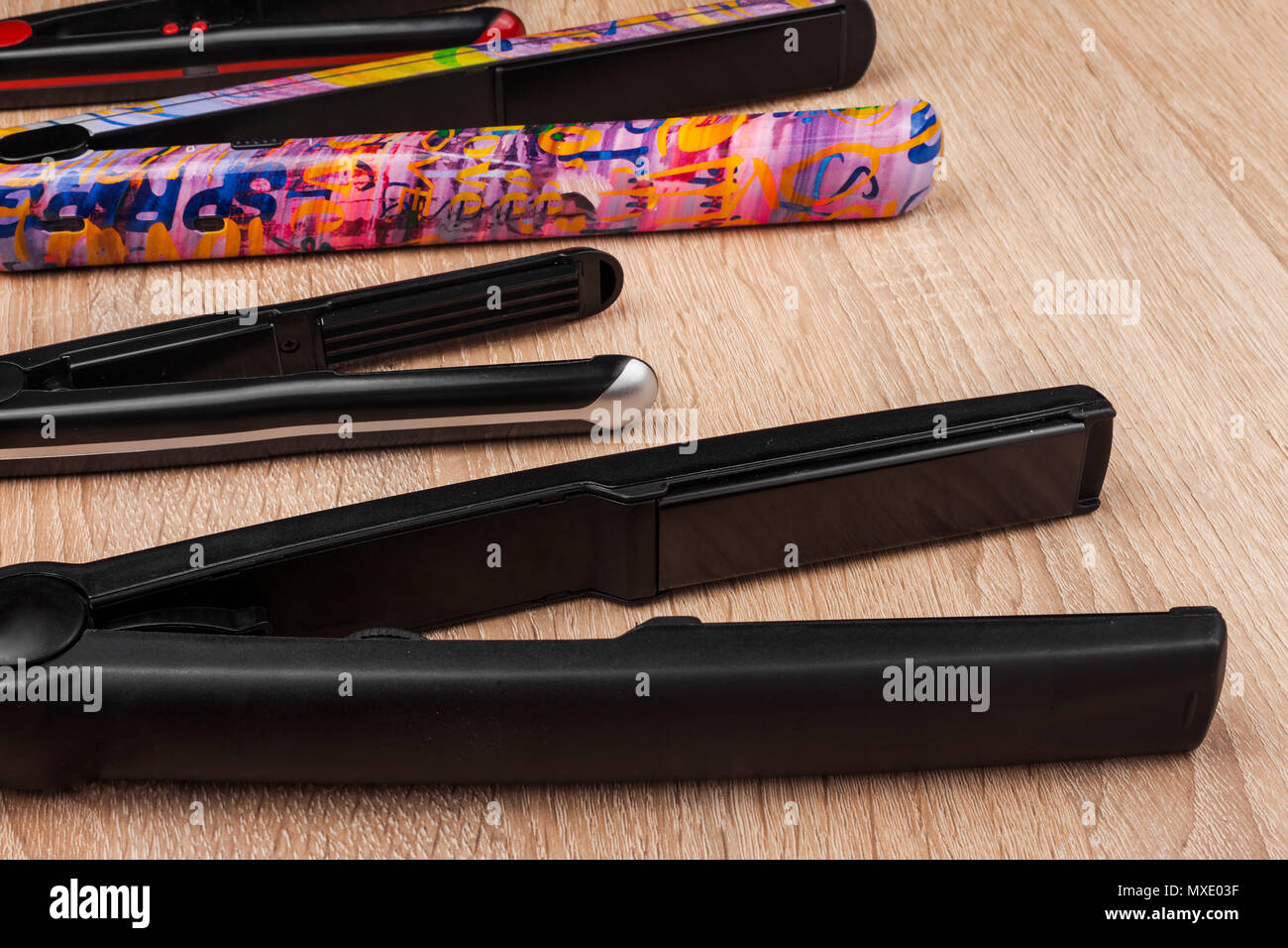 row of hair straightening irons Stock Photo Alamy