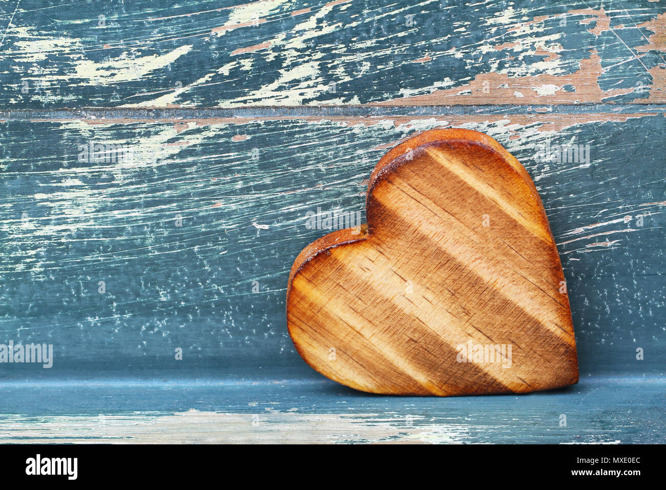 Wooden heart on rustic wooden surface with copy space Stock Photo