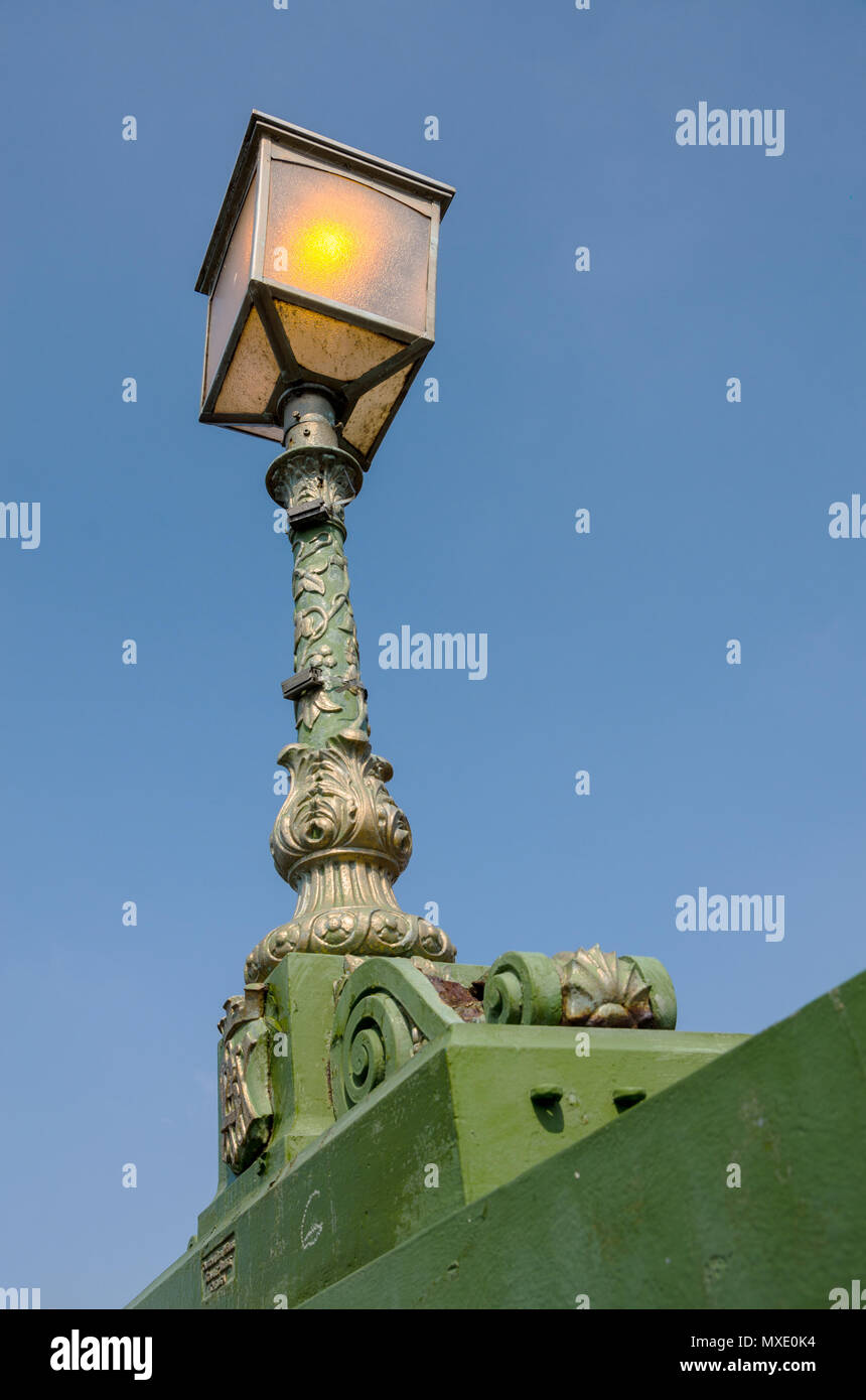 One f the ornate, decorative lamps with adorns The Hammersmith Bridge n London, UK. Stock Photo
