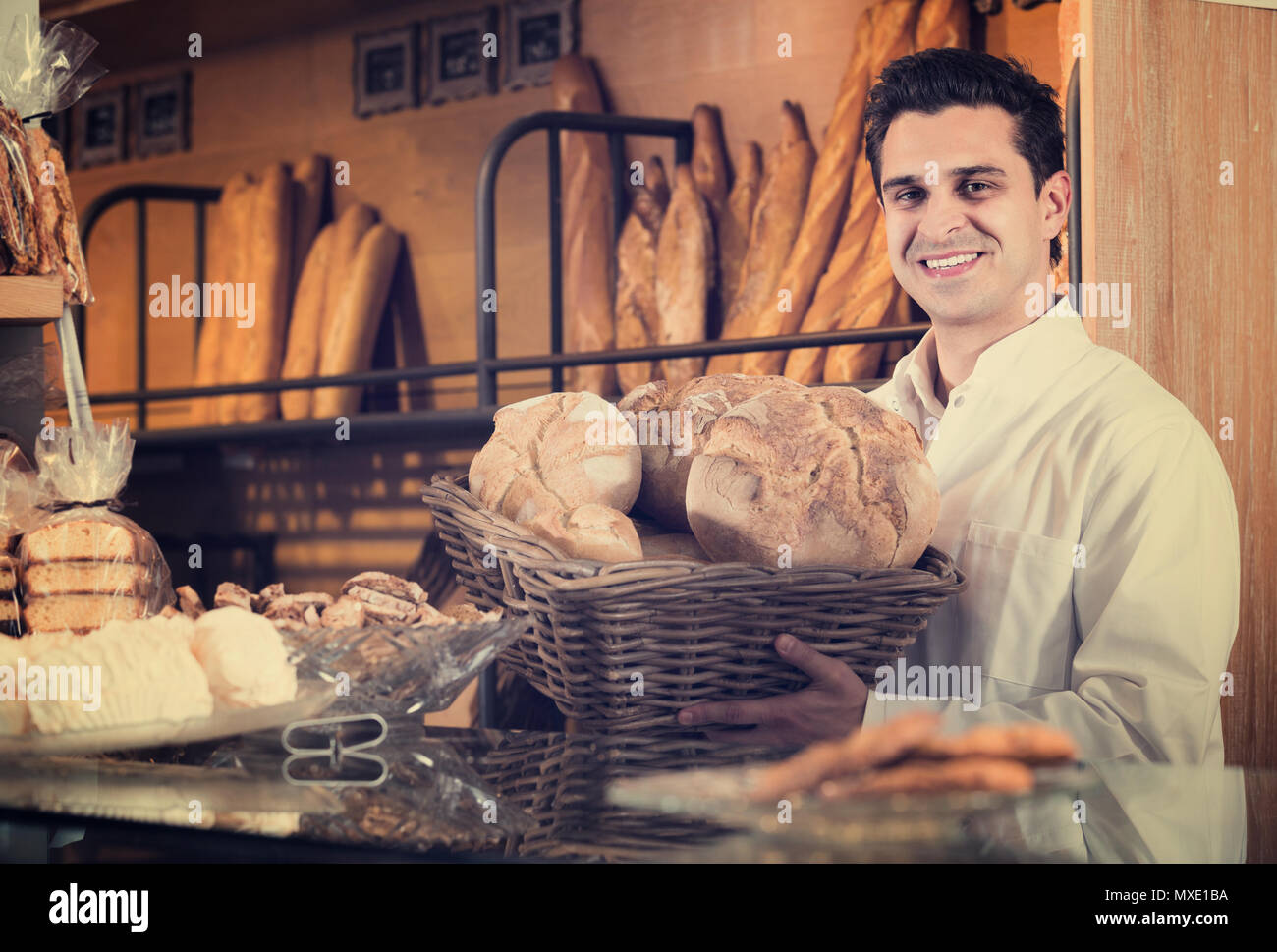 Man selling pastry and baguettes in local bakery Stock Photo Alamy