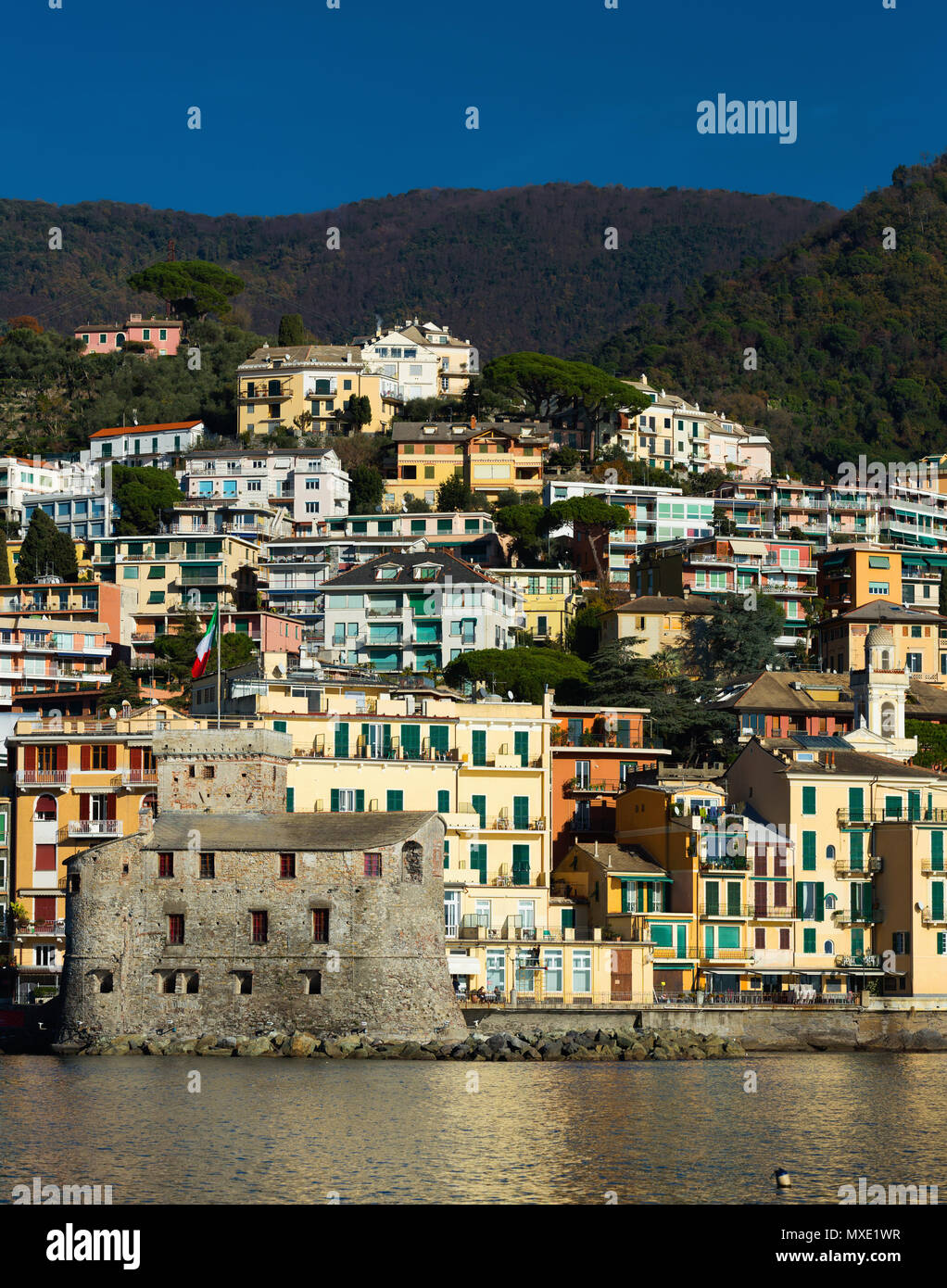 Rapal View of castle at Rapallo from bay against backdrop of colorful houses ...