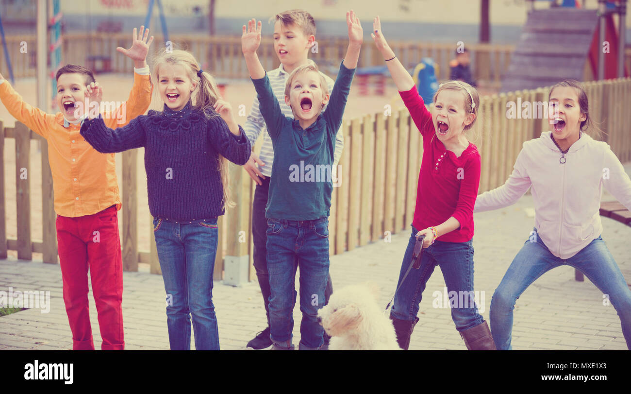 Group of five happy children jumping outdoors., Group of fi…