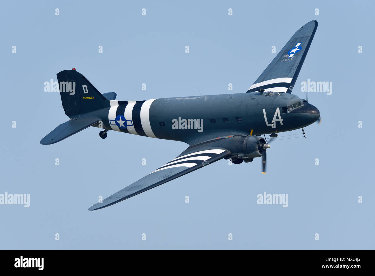 Douglas DC-3 Dakota, C-47 Skytrain. Second World War transport plane flying at an airshow. D-Day invasion stripes Stock Photo