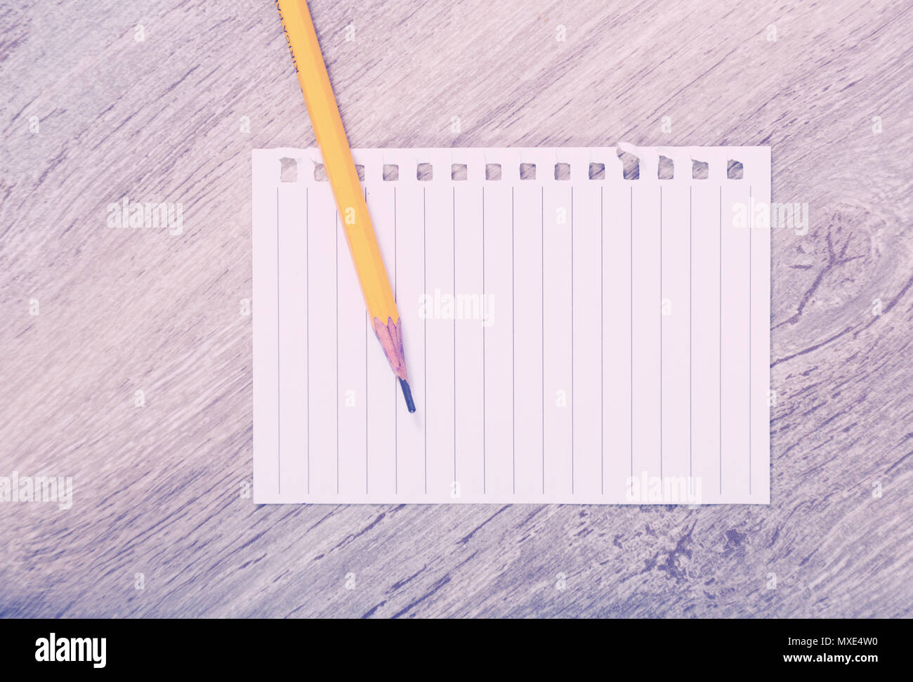 Torn sheet of notebook with pencil Stock Photo - Alamy