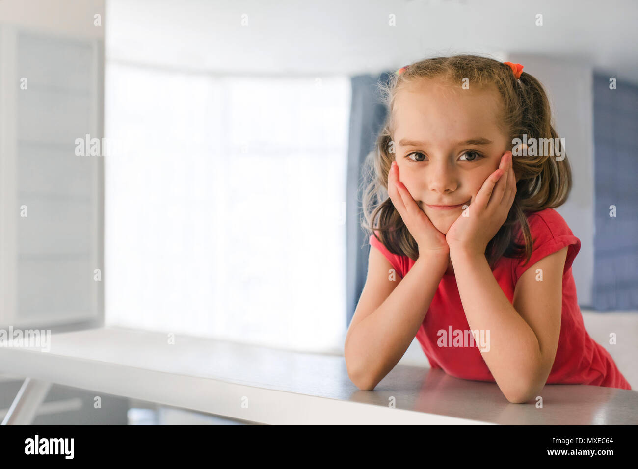 Charming girl leaning on hands Stock Photo