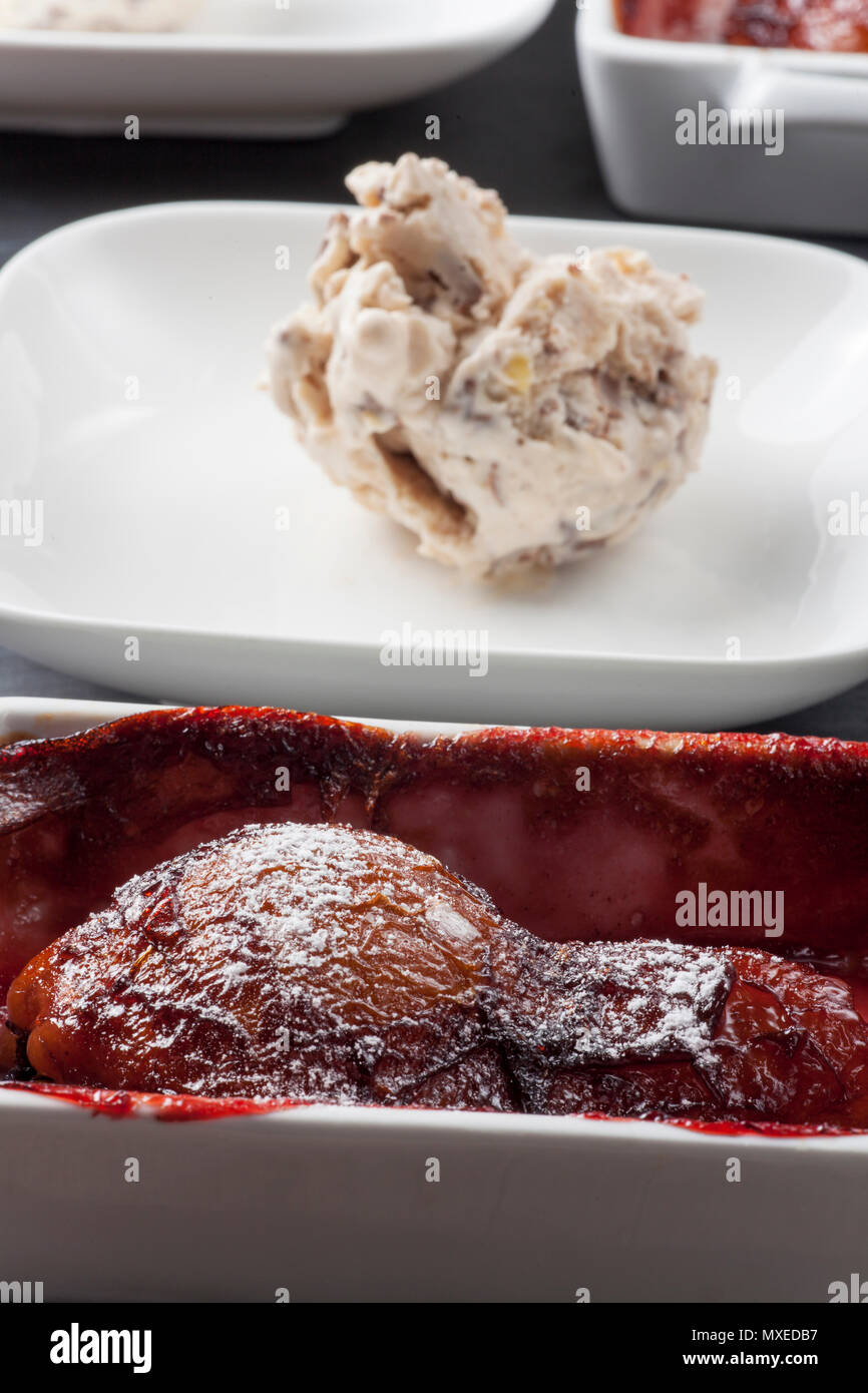 poached pear in red wine with ice cream Stock Photo