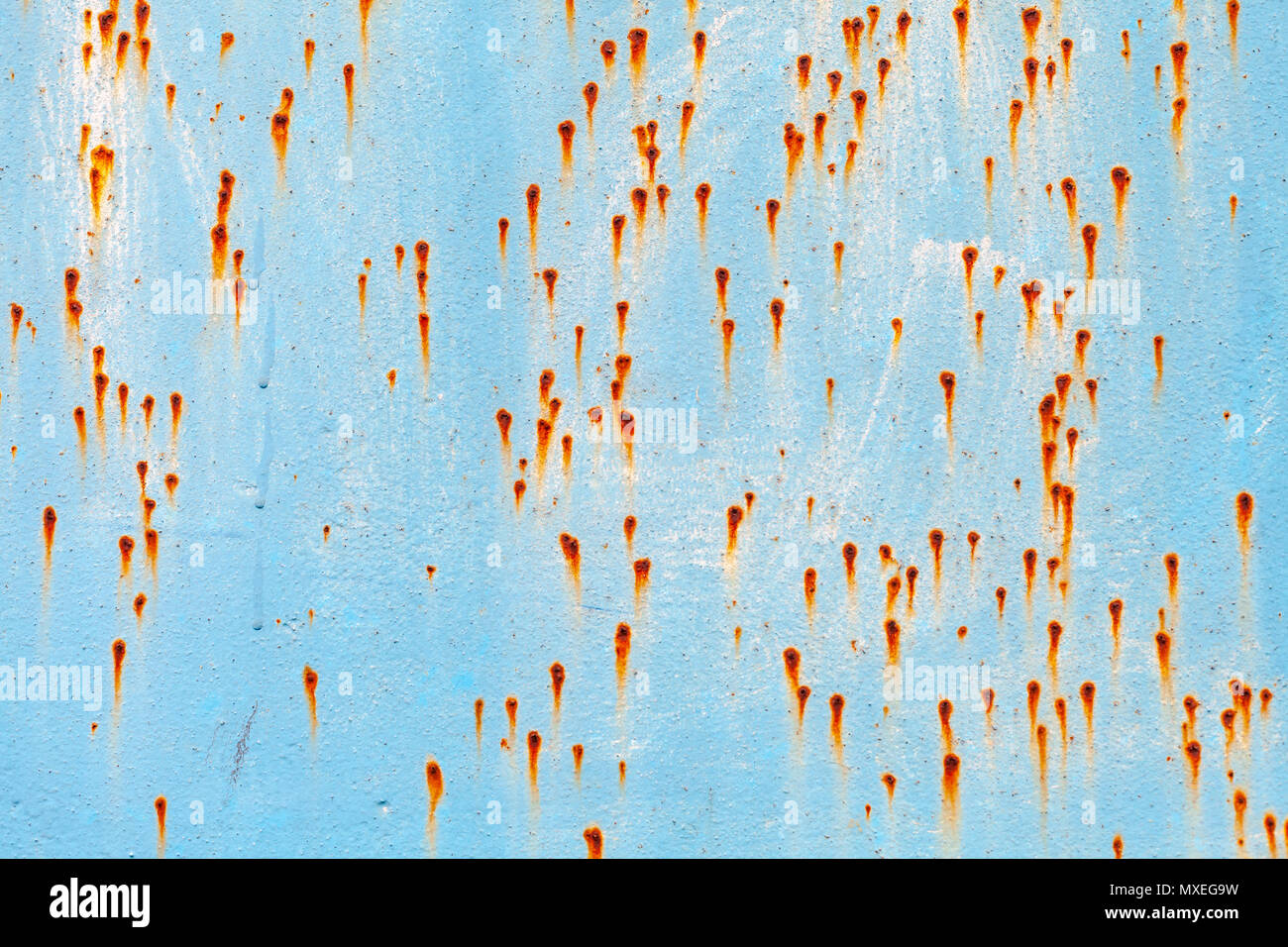 Old grungy blue metal wall with rust specks, industrial background ...