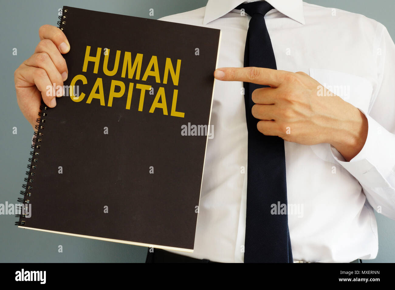Human Capital concept. Manager holding book. Stock Photo