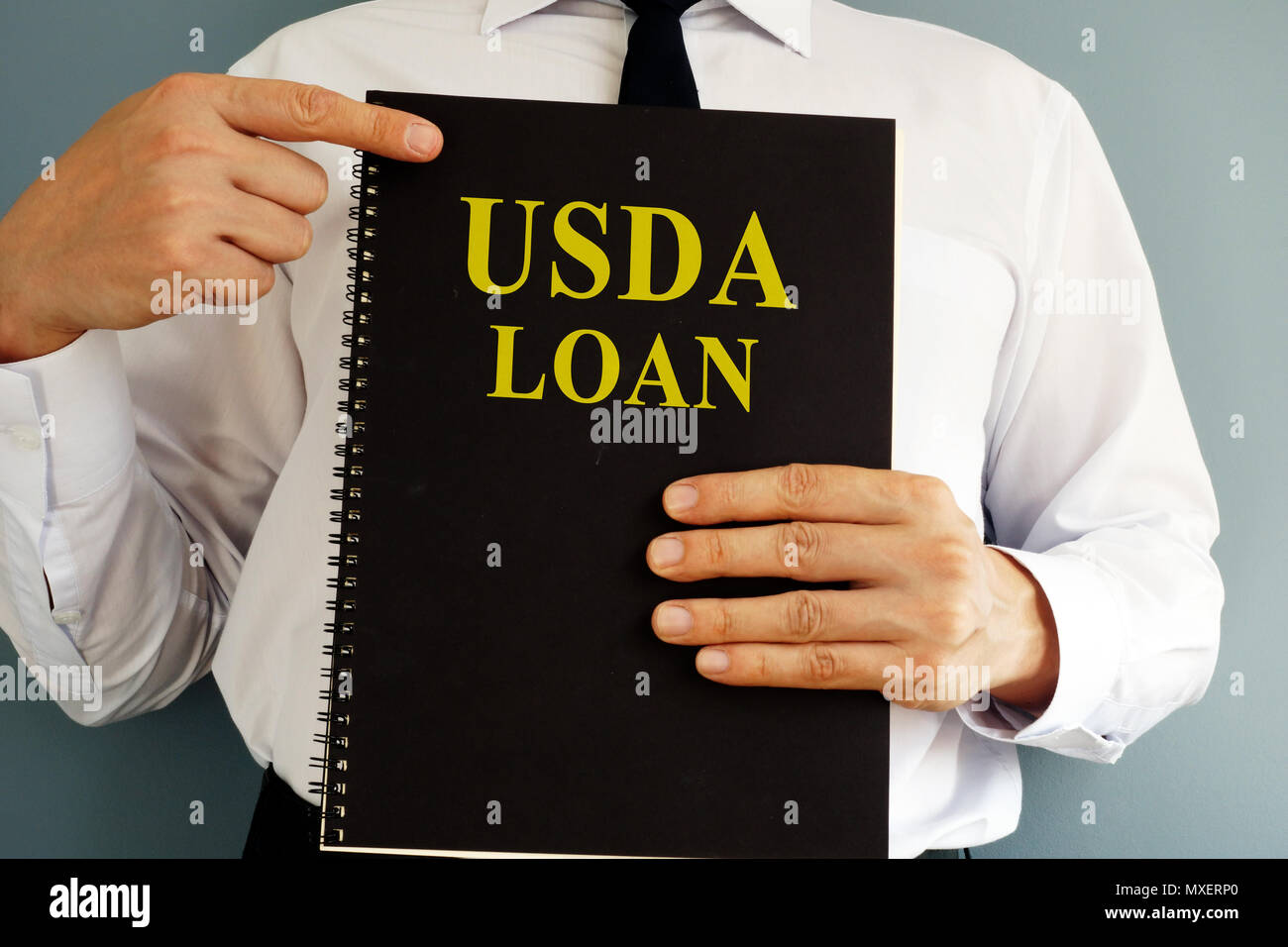 USDA Loan concept. Man holding book. Stock Photo