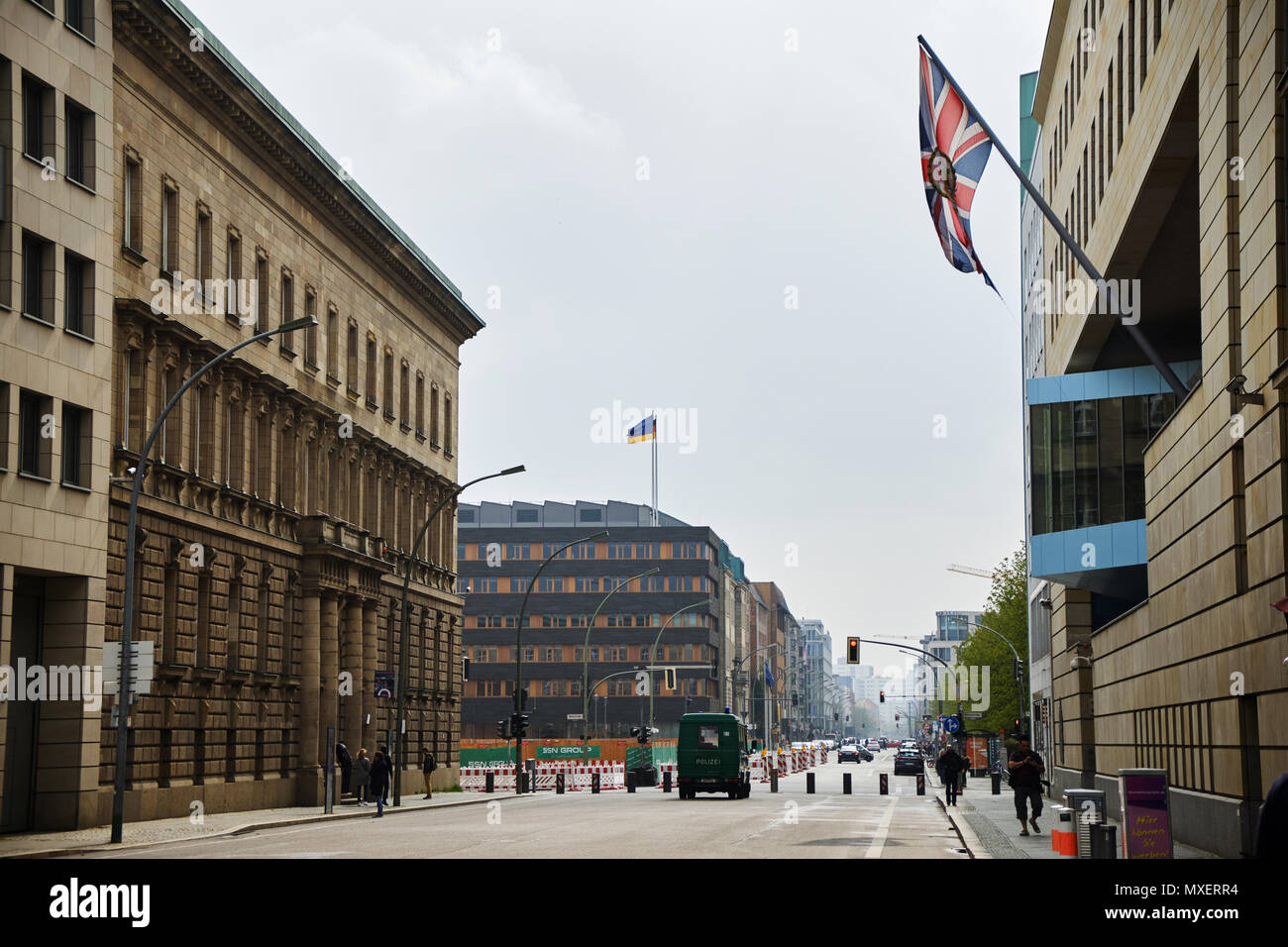 Berlin, Germany - April 14, 2018: Wilhelmstrasse with wall and flag on British Embassy building on the right and police car in the distance in Berlin Stock Photo