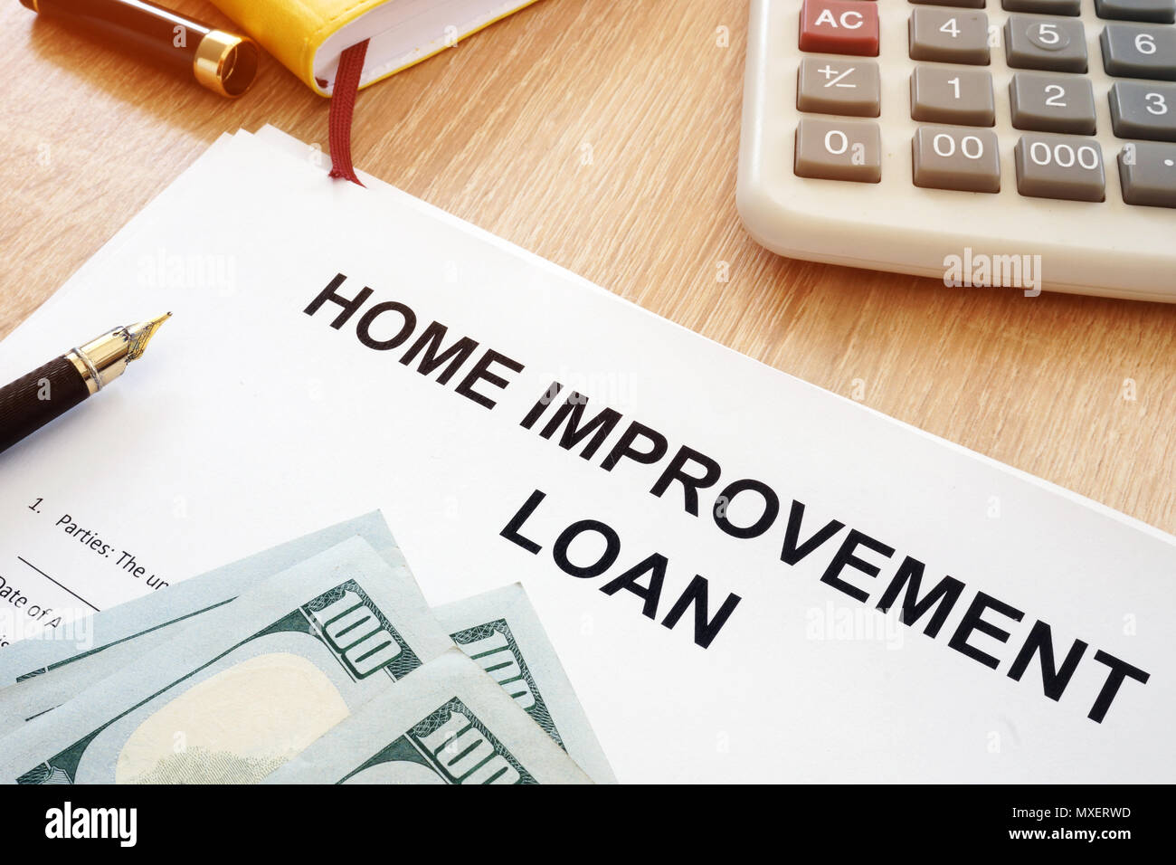 Home Improvement Loan form and money on a desk. Stock Photo