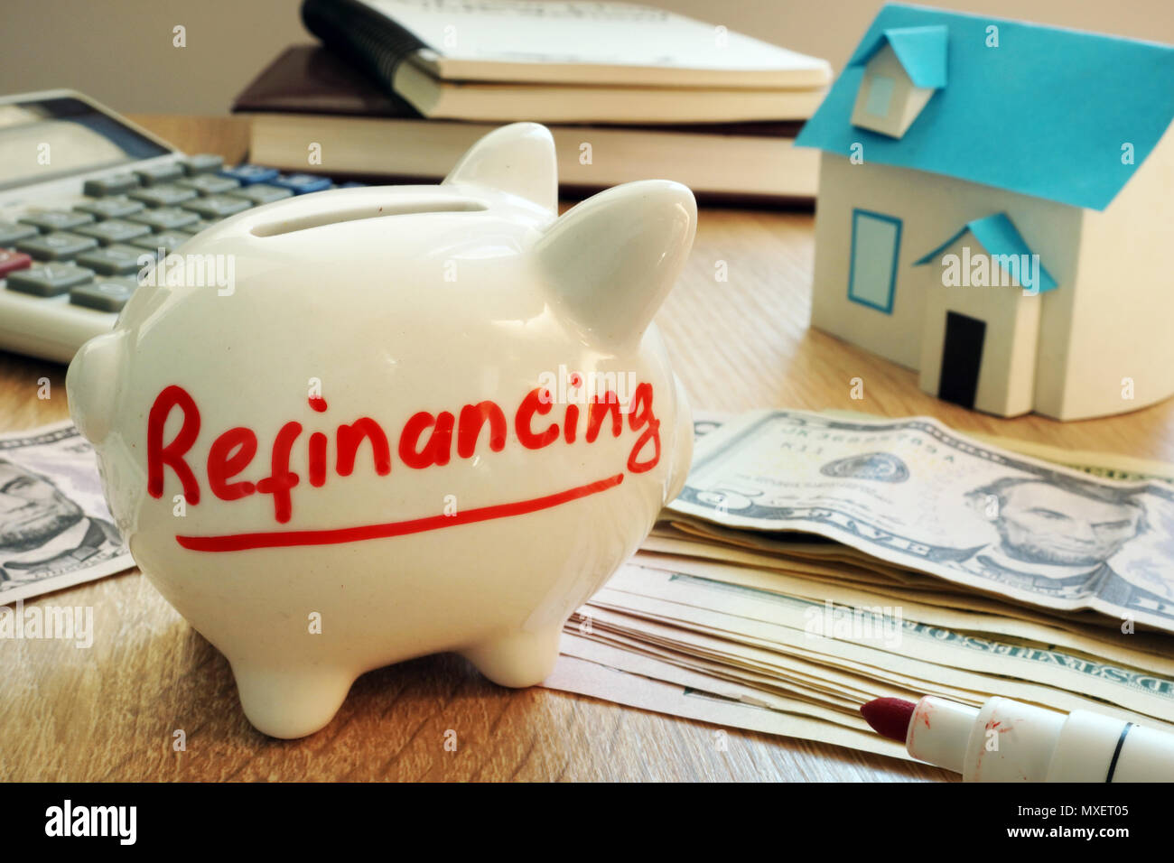 Refinancing written on a piggy bank. Stock Photo