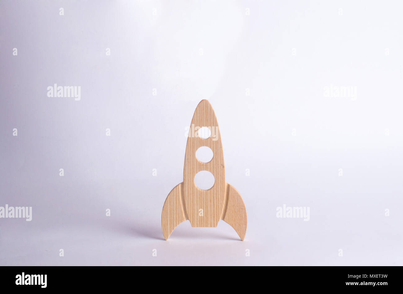 Wooden space rocket on a white background. The concept of space and technology, travel to the stars and other planets. Space tourism. Launch of spaces Stock Photo