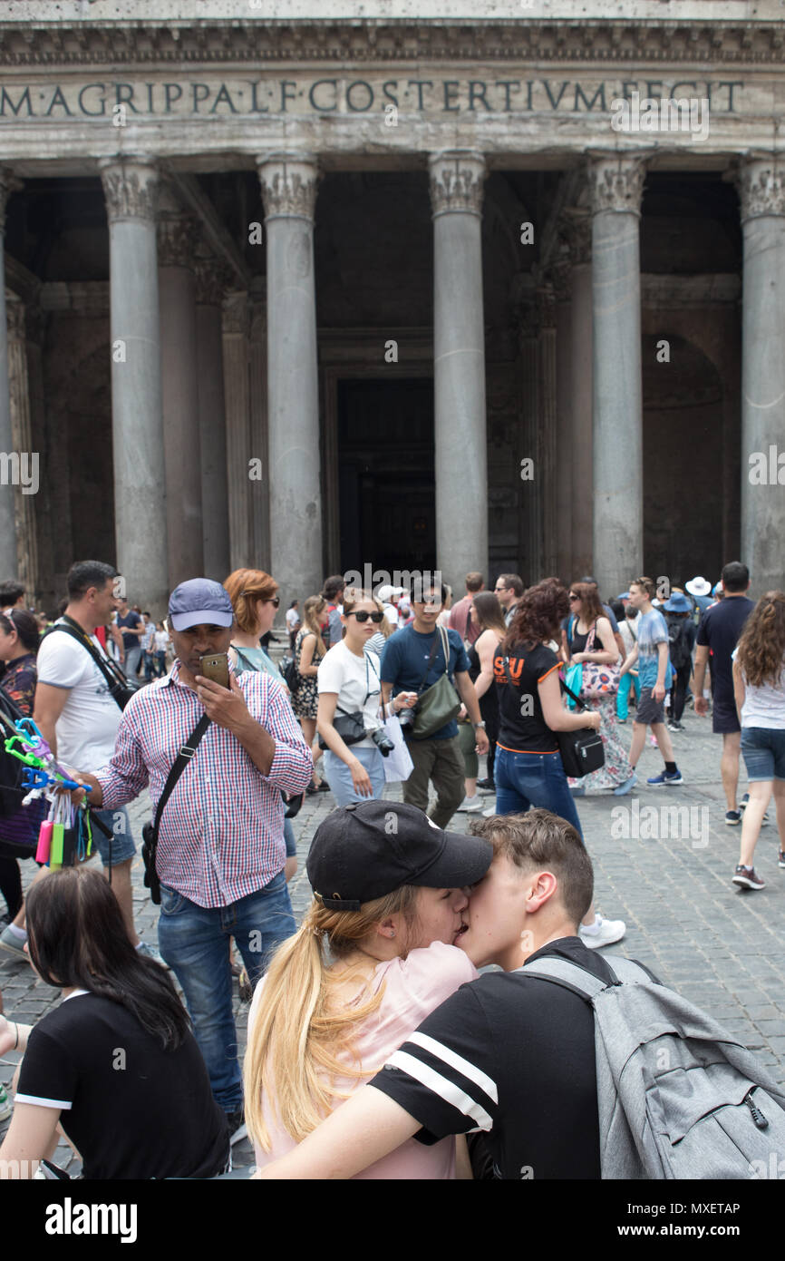 Rome Pantheon young couple kissing in front of, a lot of people tourists in the square piazza della Rotonda. Stock Photo