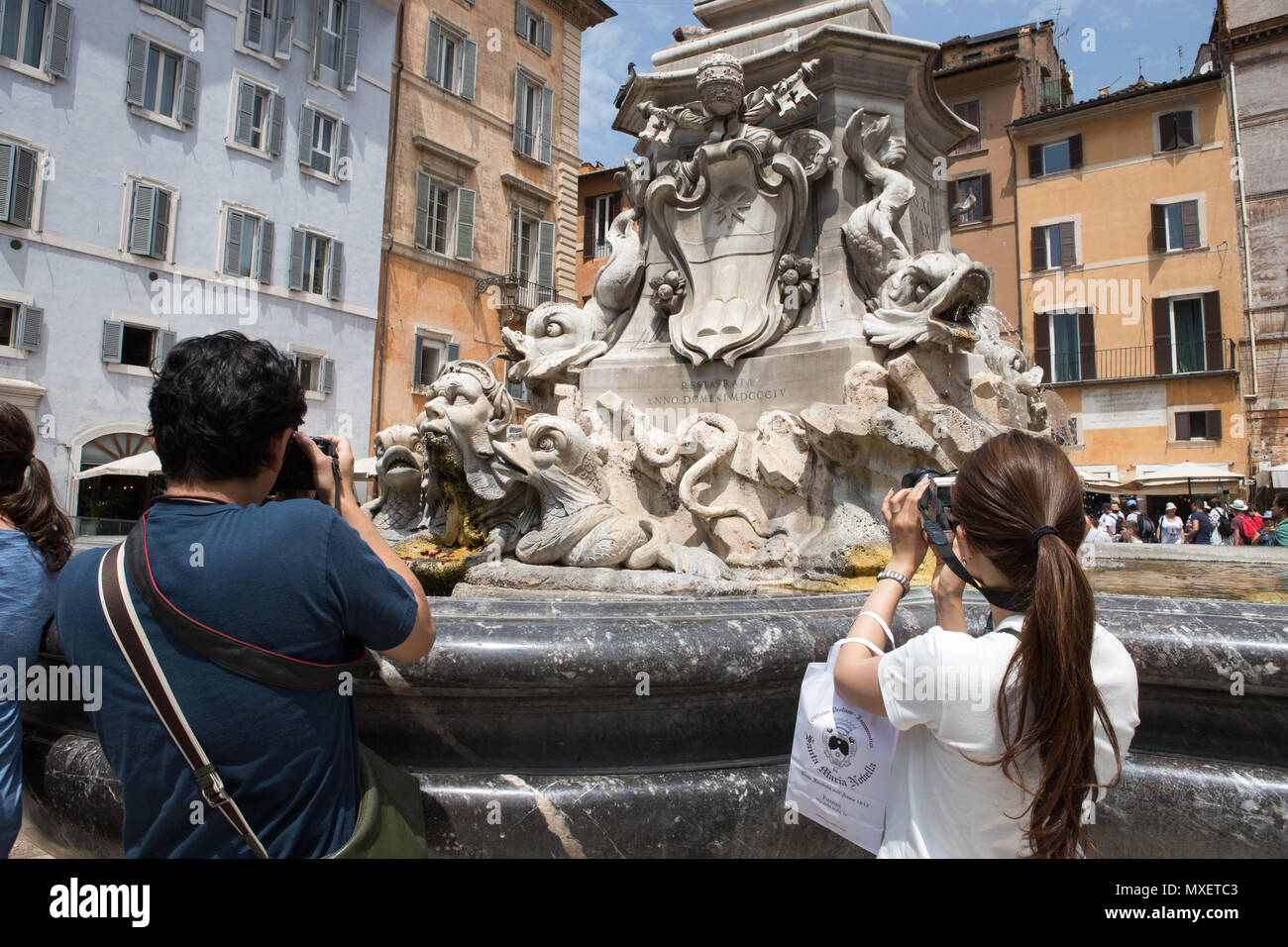 Rome Italy, tourist photographing a engraving on fountain in Piazza della Rotonda , Pantheon Piazza della Rotonda Stock Photo