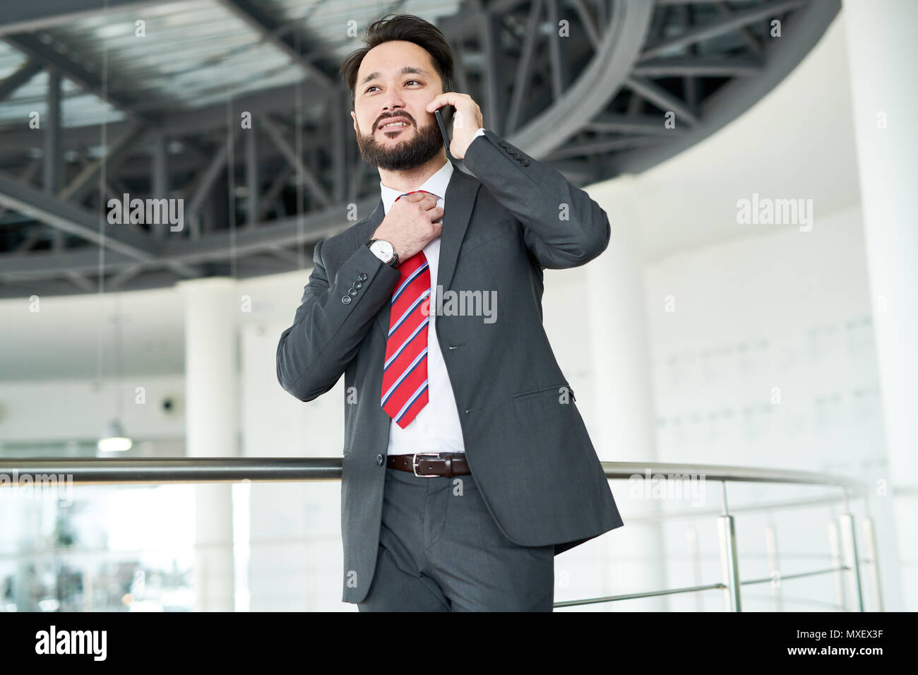 Bearded Businessman Talking on Smartphone Stock Photo