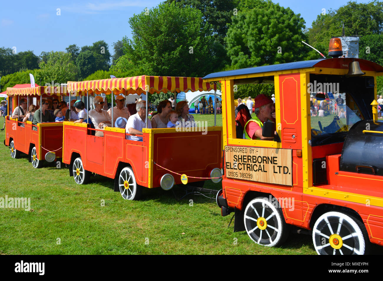 People enjoying a train ride on a hot day at the annual Sherborne Castle Country Fair, Sherborne, Dorset, England. Stock Photo