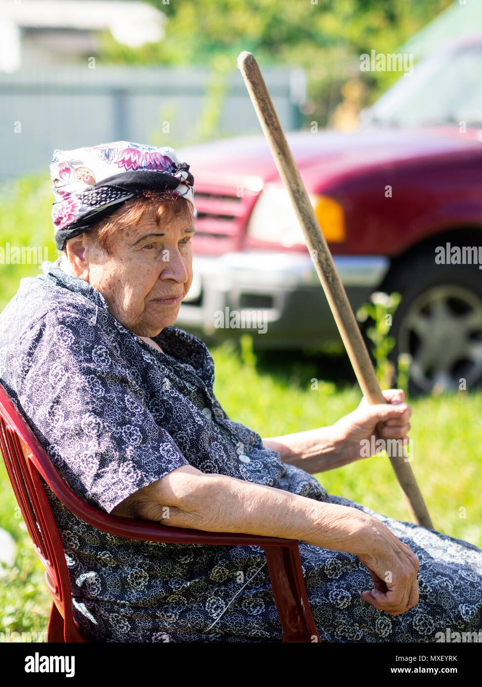 Elderly lady sitting in a chair hi-res stock photography and images - Alamy
