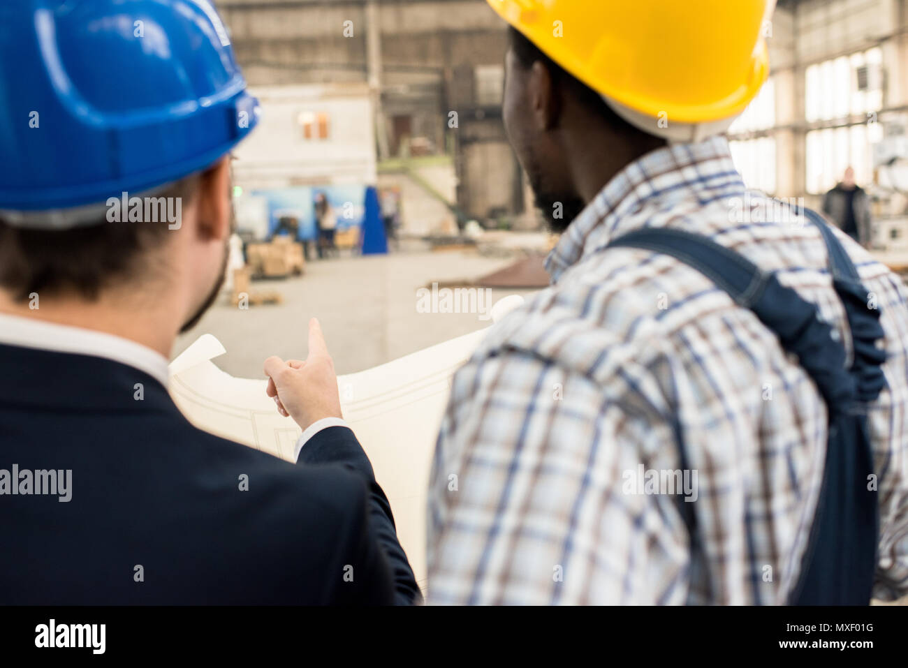 Manufacturing Conversation Discussing Manufacturing Process with Superior Stock Photo - Alamy