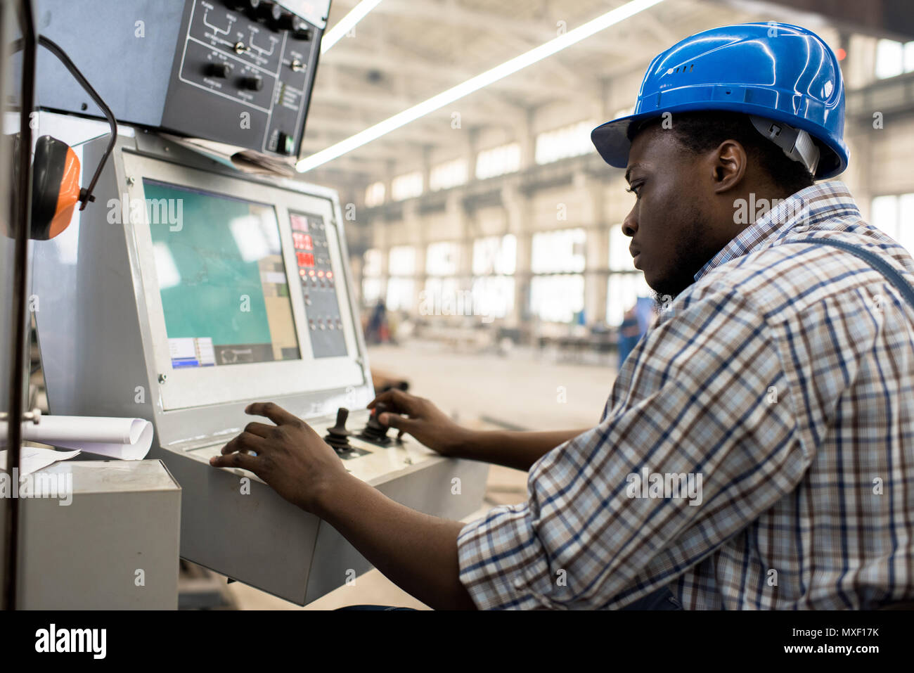 Machine Operator Focused on Work Stock Photo - Alamy