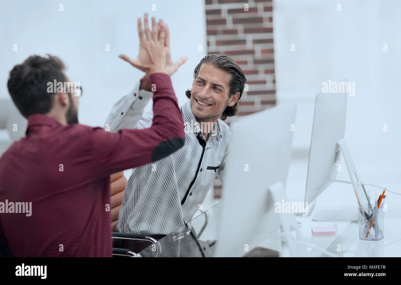 happy employees giving each other high five Stock Photo - Alamy
